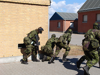 Image showing Army, soldiers and team in battle on battlefield, service or training for fitness, exercise or challenge outdoor. Military, people or mission with support for partner, bootcamp or survival at war.