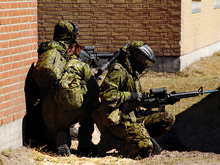 Image showing Mission, soldier and target by building with weapon for fitness, exercise or challenge outdoor with gear. Military, people and battle for workout, attack or bootcamp with camouflage for survival