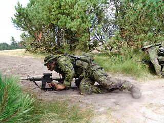 Image showing Army, soldier or target in forest with weapon for fitness, defense or challenge outdoor with gear or incognito. Military, people or hiding for battle, mission or bootcamp with camouflage for survival