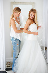 Image showing Wedding, dress and bride with girl friend in a luxury boutique, shop or store in a mall. Retail, romance and female person from Canada preparing for marriage ceremony, party or reception for love.