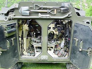 Image showing Inside, military vehicle and tools for army with gun, shovel or storage of equipment in tank. Combat, tanker and collection of supplies, guns or tactical gear for mission, war or training operation