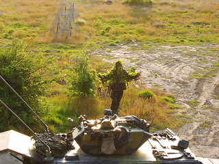 Image showing Sniper gun, camouflage and person aim, target or focus shooting at soldier, tactical mission training in nature. Battlefield, rifle gear and army shooter, warrior and military battle transportation.