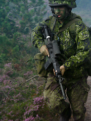 Image showing Military soldier, rifle and running in forest with camouflage for secret mission, scout or outdoor intel. Army man on route or move with gun, firearm or uniform for USA operation, terrorist or attack