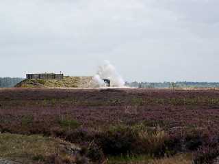 Image showing War, explosion and missile attack in the countryside during conflict or fighting for freedom with space. Sky, mockup and bomb with a cloud of smoke outdoor on a military warzone or battlefield