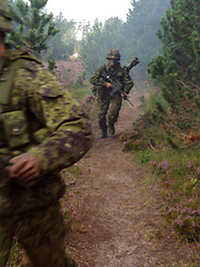 Image showing Soldier, rifle and running in forest with camouflage for secret mission, scout or outdoor intel. Army man on route or move with gun, firearm or uniform for USA military operation, terrorist or attack