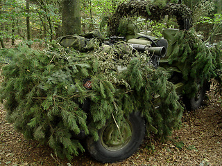 Image showing Forest, war and an army vehicle in camouflage for an attack or ambush during a special forces mission. Nature, military and a car covered in grass in the countryside for training as a soldier