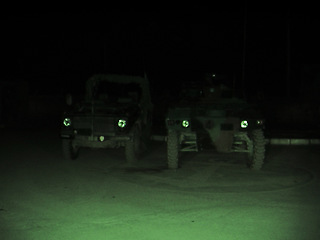 Image showing Night vision, military and vehicle in dark for army battle, target or enemy scan on battlefield or camp. Cars, transport and armed forces for attack, operation or armor outdoor with patrol or defense