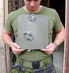 Image showing War, damage and man with bullet proof armor with holes for army or military warzone training. Conflict, metal and closeup of male warrior or soldier with equipment for protection from shooting.
