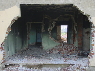 Image showing Building, warzone and destruction of a home during military conflict or turmoil during battle. Hole, damage and wall of a housing structure on a battlefield in Israel or Palestine during war