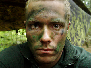 Image showing Military, man and portrait of soldier with paint for camouflage, mission or incognito at ukraine war, or service. Battle, face and person at bootcamp or battlefield for operation, protection or war