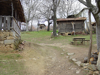 Image showing Farm, forest and a wood cabin on a path in Kosovo during 1999 after conflict during war or battle. Agriculture, sustainability and village with a house or barn in the woods on a nature landscape