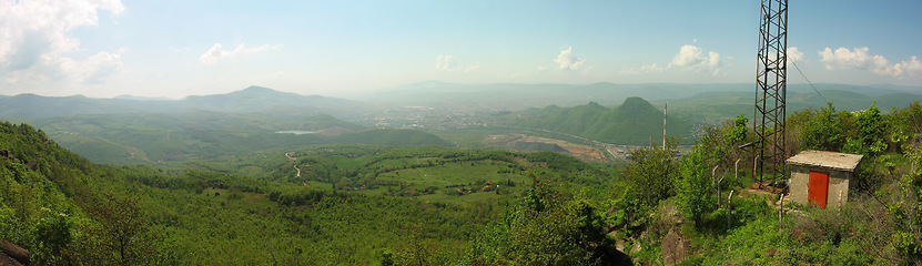 Image showing Mountain, forest and banner of radio tower with blue sky for military operation, base or outdoor checkpoint in nature. Green hills, clouds or signal antenna by shelter for communication or rendezvous