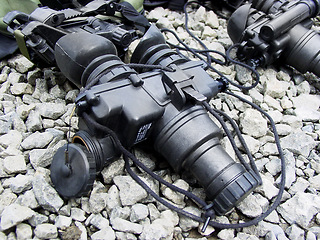 Image showing Night vision goggles, military equipment and surveillance from above for combat training or mission. War, army gadget or glasses for a tactical stealth operation closeup on the ground with stones