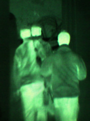 Image showing Military, night vision and target in green, overlay or dark silhouette of spy, people or terrorist risk to soldier. Police, surveillance or men training in infrared scope for army or security mission