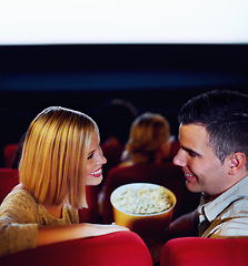 Image showing Cinema, smile and couple with popcorn, watching film or eating on romantic date together. Movie night, happy man and woman in theater with snacks, love and sitting in auditorium to relax in audience