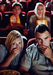 Image showing Cinema, shock and couple with popcorn, watching film or eating on romantic date together. Movie night, man and woman in theater with snacks, horror and sitting in auditorium to relax at show premier.