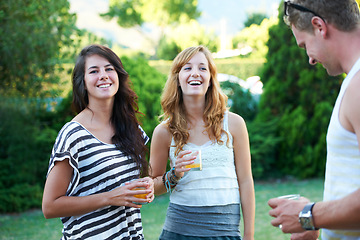 Image showing Happy, friends and drinks in backyard of home with juice, laughing and conversation in garden. BBQ, young people with talking group with smile outdoor with discussion and funny joke ready for summer