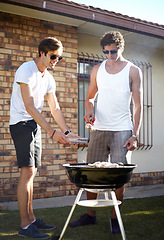 Image showing Men, grill and meat season for BBQ in the backyard with cooking and lunch with friends. Garden, food and chat outdoor with young people together ready for eating with barbecue lunch in a yard