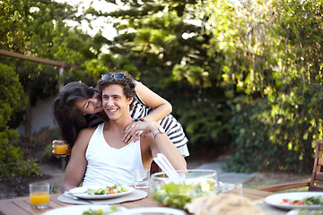 Image showing Happy, couple and hug with food outdoor in backyard for bbq with love, care and support at home. Meal, woman and smile in garden with laughing and young people together with glass and date in summer