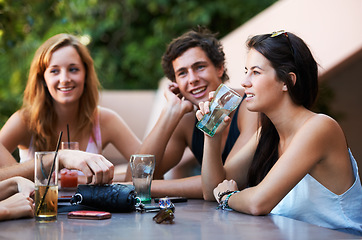 Image showing Friends, bar and drinks during conversation on the weekend for bonding, happiness and social. Table, alcohol and people, men or women speaking at an outdoor restaurant for a group chat or drinking