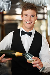 Image showing Man, bartender and waiter with champagne at restaurant for happy hour, hospitality industry or customer service. Portrait of barman, server or catering employee smile, wine glass and alcohol bottle