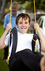 Image showing Portrait, boy and swing at park with father for fun, childhood freedom and energy together. Happy young kid swinging with dad in garden, playground and outdoor for bonding, break and enjoy playing