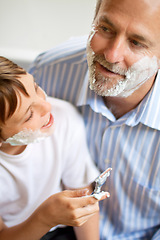 Image showing Family, father and son learning to shave in the bathroom of a home together closeup from above. Razor, shaving cream and a man teaching his boy child about skincare or grooming while bonding