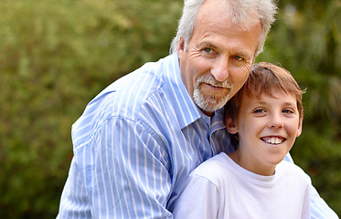 Image showing Elderly, man or son with hug in nature outdoor at a park, backyard or environment for bonding and care. Family, father or child with embrace for love, support and relationship with happiness or smile