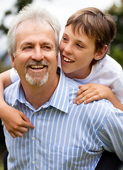 Image showing Happy grandfather, child and piggyback outdoor for fun, fathers day and bonding with love, care and smile. Senior man, grandparent and carrying boy kid at park for freedom, play and relax with family