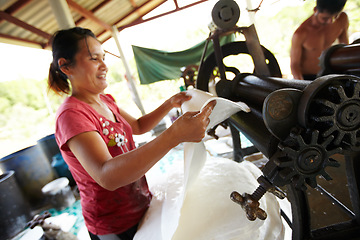 Image showing Rubber, industry and Asian woman with roller in workshop, factory and outdoor warehouse in nature. Manufacturing, plantation and person with machine for rolling latex, plastic and material production