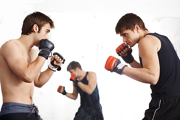Image showing Men, fighting and martial arts training in ring with sparring partner for self defense techniques at dojo. Male person or fighter in kick boxing, karate or MMA for jujitsu match, sports or face off