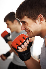 Image showing Man, martial arts and fitness, fist and fight with kickboxing, MMA and battle, power and athlete in gym. Exercise, combat sport and boxing with strong boxer in club, workout and training with glove