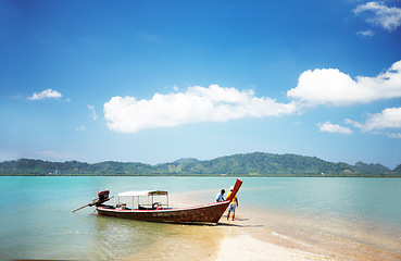 Image showing Boat, transport and travel, beach and ocean with people and paradise, tropical island with nature and vacation. Holiday in Thailand with transportation, sea vessel for fishing and outdoor adventure