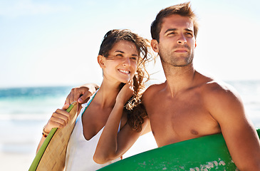 Image showing Couple, beach and surf, holiday and travel with summer and bonding outdoor, sport and people on a date. Ocean, wind and view with surfing, man and woman in relationship, fun activity and adventure