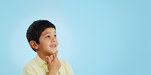 Image showing Surprise, boy and child with decision, thinking and brainstorming on a blue studio background. Ideas, mockup space and happy kid looking up, future and announcement with planning, choice and emoji