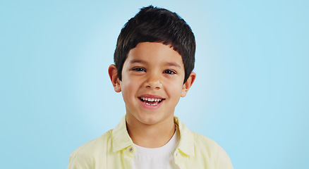 Image showing Face, boy child and smile in studio for wellness and confidence on a blue background with positive mindset. Portrait, kid and happiness with casual fashion, joyful and relaxed expression on mockup