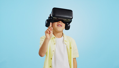 Image showing VR, child and glasses with video gaming, technology and metaverse online in studio. Young boy, gamer and augmented reality app for streaming and virtual graphic on internet with blue background