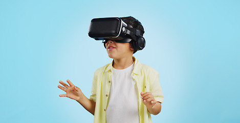 Image showing Glasses, virtual reality and child in metaverse, 3d games or futuristic technology for school or futuristic e learning in studio. Kid with high tech, VR education and watch video on a blue background