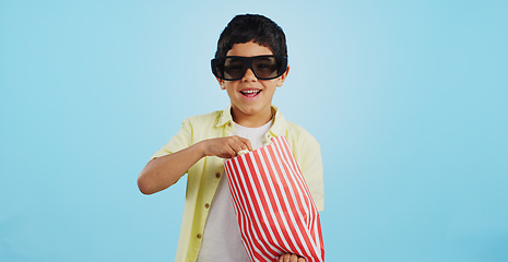 Image showing Popcorn, 3d or child in studio for a movie, watching tv or VR film on blue background with snack. Future technology, virtual reality experience or kid eating food for 3d cinema or metaverse show