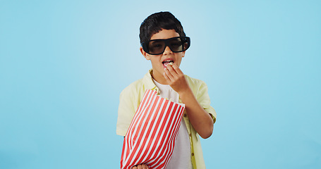Image showing Popcorn, 3d or child in studio for a movie, watching tv or VR film on blue background with snack. Future technology, virtual reality experience or kid eating food for 3d cinema or metaverse show