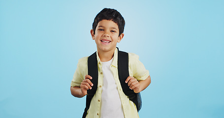 Image showing School, happy or face of child in studio on blue background ready for class, learning and education. Student, smile or portrait of a young boy with bag excited for lesson, academy or kindergarten