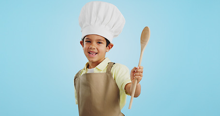 Image showing Happy, face and child with a spoon for baking, young chef or getting ready for the kitchen. Smile, boy kid or portrait with equipment for cooking, future career or preparation on a studio background