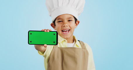 Image showing Chef kid, face or phone green screen in studio for social media, cooking tutorial ads or download. Blue background, space or happy child with notification for online marketing, mockup or advertising