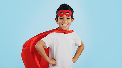 Image showing Happy, superhero or face of child with smile to fight in fantasy, dream or cosplay costume in studio. Boy power, brave or strong kid ready to protect freedom or justice with a mask on blue background