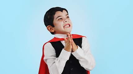 Image showing Choice, halloween and excited child in costume ready for event, hungry and isolated in a studio blue background. Option, checklist and funny young kid with comedy, joy and happiness for holiday