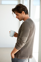 Image showing Coffee, handsome and young man at apartment with memory, vision or reflection face expression. Thinking, morning and male person from Canada with latte, cappuccino or espresso with an idea at home.