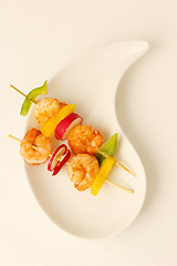 Image showing Prawn, kebab and food on plate with shrimp, vegetables and luxury menu, meat or fine dining mockup. Grilled, seafood and creative presentation of gourmet appetizer on skewers in restaurant or studio