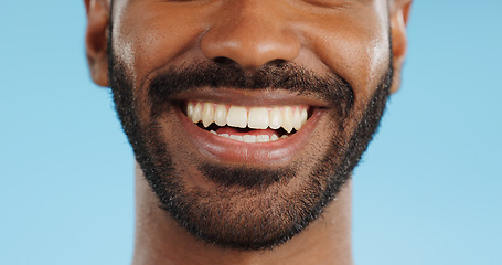 Image showing Smile, closeup and black man with teeth in studio, blue background and mockup space with happiness or advertising. Portrait, closeup and marketing for skincare, wellness or healthy dermatology care