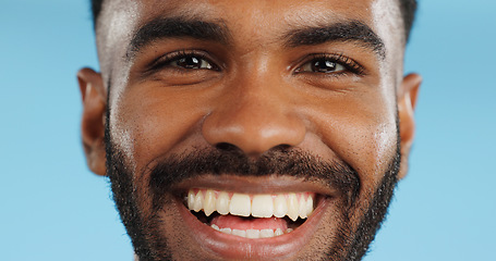 Image showing Happy, smile and face of black man in studio, blue background and mockup space with happiness or advertising. Portrait, closeup and marketing for skincare, wellness or healthy dermatology care