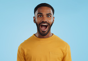 Image showing Wow and excited black man in studio isolated on a blue background mockup space. Portrait, surprise and happy person in shock for good news, information and winner of bonus promotion